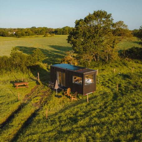 Drone view of the Tiny House set in a meadow