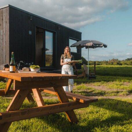Donna che si sistema sul tavolo da picnic per l&#039;aperitivo