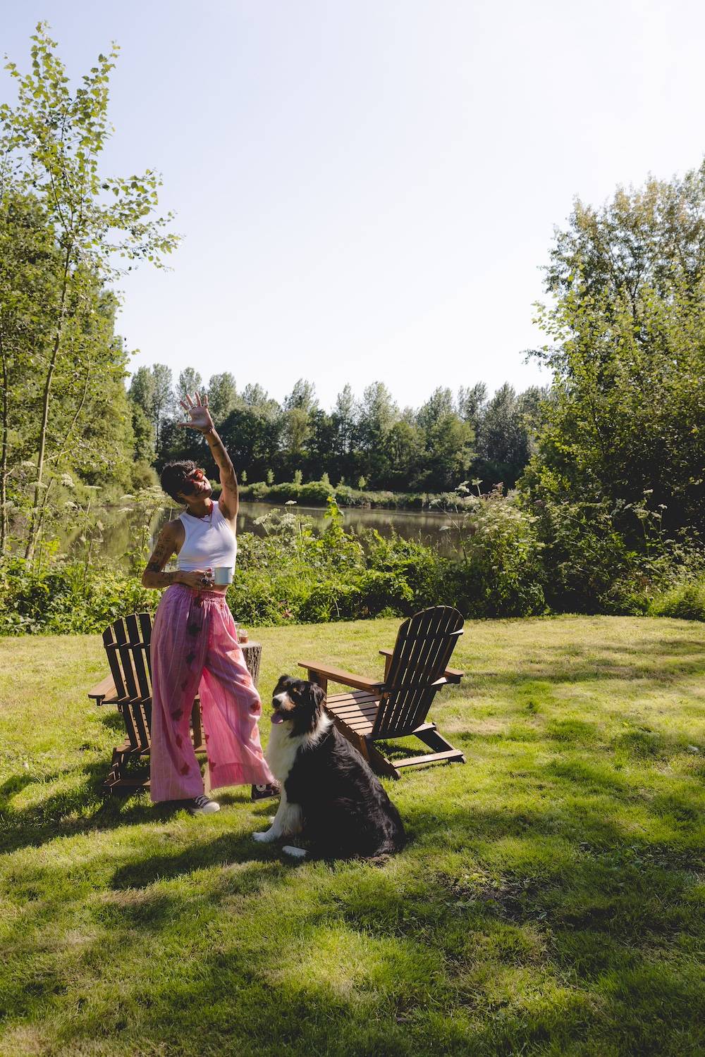 Femme avec son chien dans l'herbe profitant d'un séjour dog friendly
